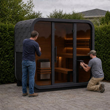 Bettr sauna assembly — installer securing the front panel on a 4-Person Ritual sauna